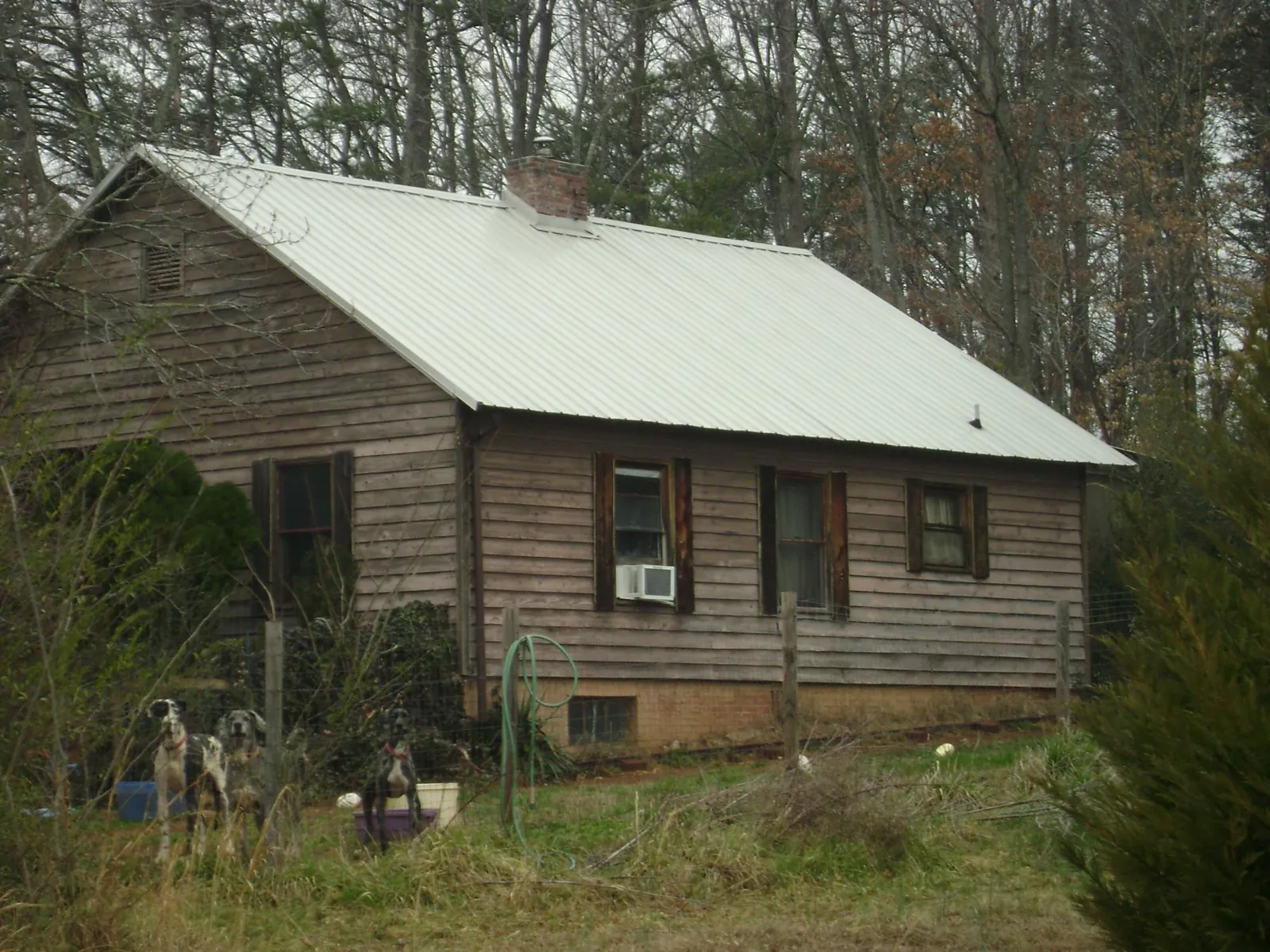 White metal roof on an old wood sided farmhouse, from a Metal Roof Installation job in Harrison